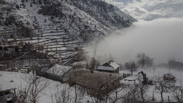 Fog covers a valley on right after a snowfall on the outskirts of Srinagar, Indian controlled Kashmir, Tuesday, Dec. 12, 2017 - Sputnik International