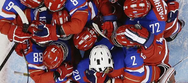 Members of Team Russia hug after defeating Japan 6-3 during the 2014 Winter Olympics women's ice hockey game at Shayba Arena Sunday, Feb. 16, 2014, in Sochi, Russia Members of Team Russia hug after defeating Japan 6-3 during the 2014 Winter Olympics women's ice hockey game at Shayba Arena Sunday, Feb. 16, 2014, in Sochi, Russia - Sputnik International