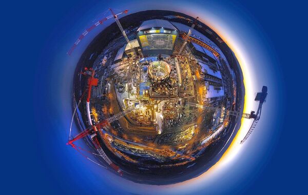 Circular lens view of the construction of the ITER facility. - Sputnik International