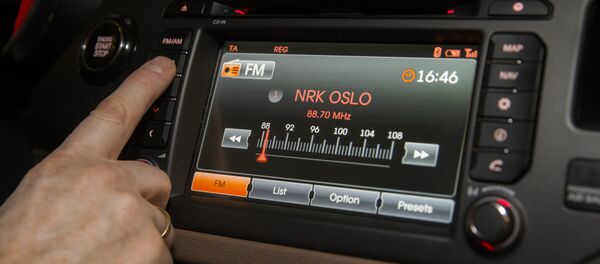 A man looks for a radio station inside a car in Oslo on January 10, 2017 - Sputnik International