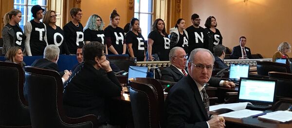 Abortion-rights activists stand in protest on Wednesday, Dec. 13, 2017, in the Ohio Senate chamber in Columbus, after passage of a bill banning abortions in cases of a Down syndrome diagnosis Abortion-rights activists stand in protest on Wednesday, Dec. 13, 2017, in the Ohio Senate chamber in Columbus, after passage of a bill banning abortions in cases of a Down syndrome diagnosis - Sputnik International
