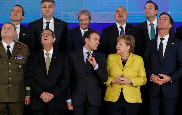 Cyprus President Nicos Anastasiades, French President Emmanuel Macron, German Chancellor Angela Merkel and Dutch Prime Minister Mark Rutte take part in a group photo on the launching of the Permanent Structured Cooperation, or PESCO, a pact between 25 EU governments to fund, develop and deploy armed forces together, during a EU summit in Brussels, Belgium, December 14, 2017 - Sputnik International