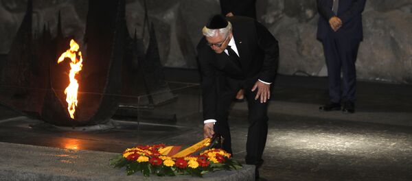 German President Frank-Walter Steinmeier (C), escorted by his wife Elke Budenbender (L) and the chairman of the Yad Vashem Holocaust Memorial museum, Avner Shalev (R), lays a wreath at the Hall of Remembrance, where the names of major death and concentration camps are written, during his visit to Yad Vashem commemorating the six million Jews killed by Nazis during World War II, in Jerusalem on May 7, 2017 German President Frank-Walter Steinmeier (C), escorted by his wife Elke Budenbender (L) and the chairman of the Yad Vashem Holocaust Memorial museum, Avner Shalev (R), lays a wreath at the Hall of Remembrance, where the names of major death and concentration camps are written, during his visit to Yad Vashem commemorating the six million Jews killed by Nazis during World War II, in Jerusalem on May 7, 2017 - Sputnik International