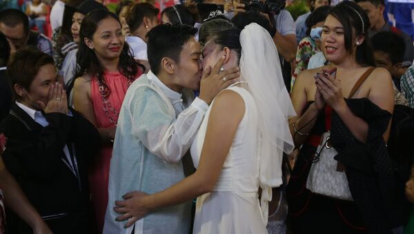 Filipino LGBT (Lesbians Gays Bisexual and Transgenders) couple Loida Romero, right, and Marissa Reglos kiss during a Rite of Holy Union ceremony in suburban Quezon city, Manila, Philippines on Sunday, June 28, 2015 - Sputnik International