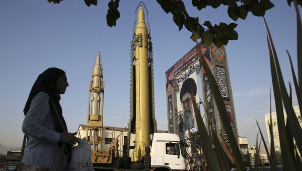 A Ghadr-H missile, center, a solid-fuel surface-to-surface Sejjil missile and a portrait of the Supreme Leader Ayatollah Ali Khamenei are displayed at Baharestan Square in Tehran, Iran - Sputnik International
