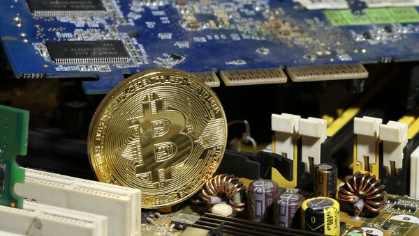 A copy of bitcoin standing on PC motherboard is seen in this illustration picture, October 26, 2017 - Sputnik International