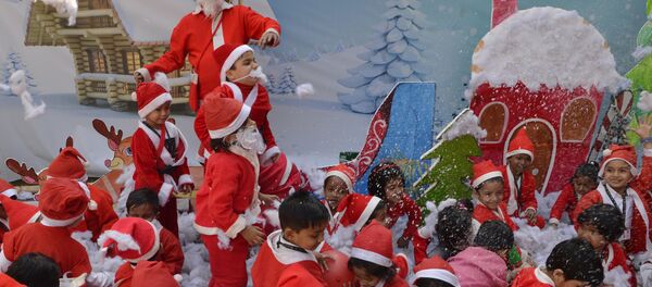 Indian school children dressed as Santa Claus take part in a Christmas event at a school in Siliguri Indian school children dressed as Santa Claus take part in a Christmas event at a school in Siliguri - Sputnik International