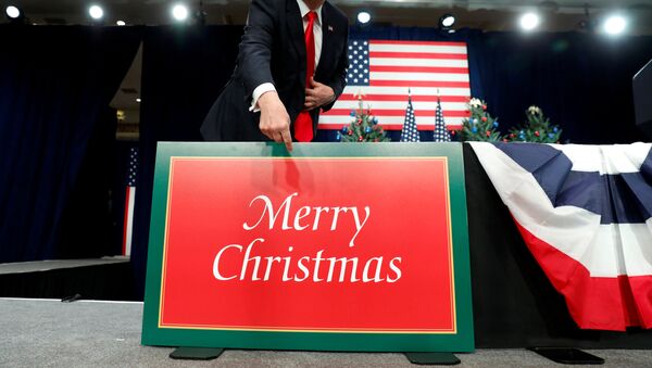 U.S. President Donald Trump points to a large Merry Christmas card on the stage as he arrives to deliver remarks on tax reform in St. Louis, Missouri, U.S. November 29, 2017 - Sputnik International