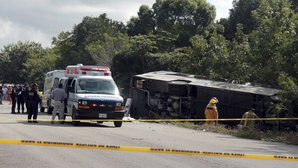 An ambulance sits parked next to an overturned bus in Mahahual, Quintana Roo state, Mexico - Sputnik International