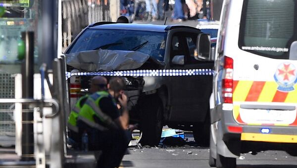 Police sit in front of a crashed vehicle after a driver was arrested after ploughing into pedestrians at a crowded intersection near the Flinders Street train station in central Melbourne, Australia December 21, 2017 - Sputnik International