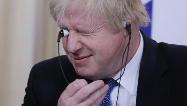British Foreign Secretary Boris Johnson holds earphones during a news conference following the talks with Russian Foreign Minister Sergei Lavrov in Moscow, Russia December 22, 2017 - Sputnik International