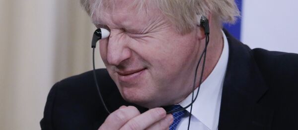 British Foreign Secretary Boris Johnson holds earphones during a news conference following the talks with Russian Foreign Minister Sergei Lavrov in Moscow, Russia December 22, 2017 - Sputnik International