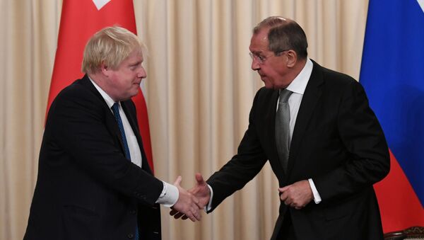 Britain's Foreign Secretary Boris Johnson and his Russian counterpart Sergei Lavrov shake hands at a news conference following their meeting, in Moscow, Russia - Sputnik International