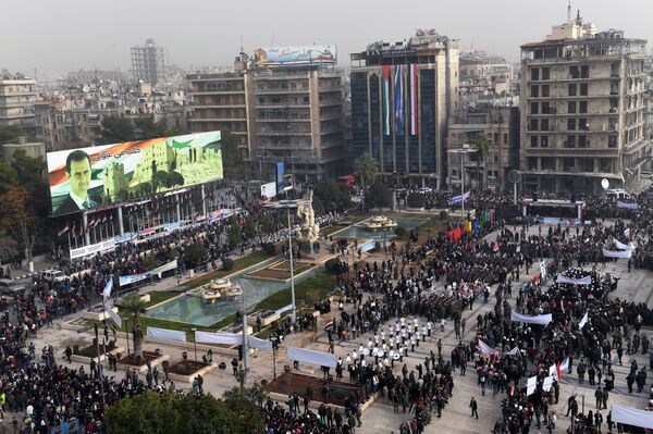 A picture taken on December 21, 2017 shows an elevated view of the square of Saadallah al-Jabiri as marching bands, soldiers, and civilians gather in a government celebration marking the first anniversary of the retaking of the second Syrian city of Aleppo - Sputnik International