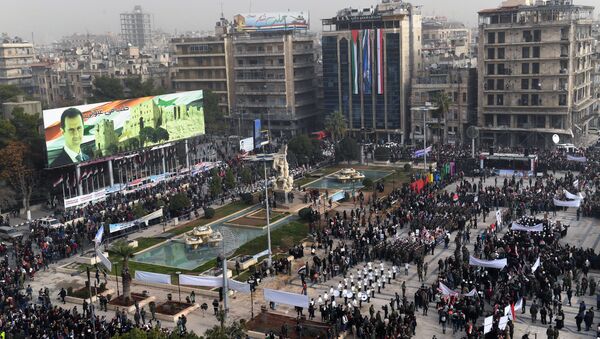 A picture taken on December 21, 2017 shows an elevated view of the square of Saadallah al-Jabiri as marching bands, soldiers, and civilians gather in a government celebration marking the first anniversary of the retaking of the second Syrian city of Aleppo - Sputnik International