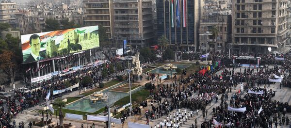 A picture taken on December 21, 2017 shows an elevated view of the square of Saadallah al-Jabiri as marching bands, soldiers, and civilians gather in a government celebration marking the first anniversary of the retaking of the second Syrian city of Aleppo - Sputnik International
