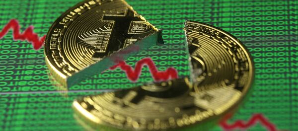 Broken representation of the Bitcoin virtual currency, placed on a monitor that displays stock graph and binary codes, are seen in this illustration picture, December 21, 2017 Broken representation of the Bitcoin virtual currency, placed on a monitor that displays stock graph and binary codes, are seen in this illustration picture, December 21, 2017 - Sputnik International