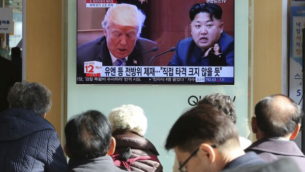 FILE- In this Tuesday, Nov. 21, 2017, file photo, people watch a TV screen showing images of U.S. President Donald Trump, left, and North Korean leader Kim Jong Un at Seoul Railway Station in Seoul, South Korea - Sputnik International