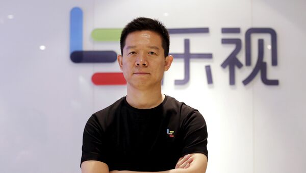 Jia Yueting, co-founder and head of Le Holdings Co Ltd, also known as LeEco and formerly as LeTV, poses for a photo in front of a logo of his company after a Reuters interview at LeEco headquarters in Beijing, China April 22, 2016 - Sputnik International