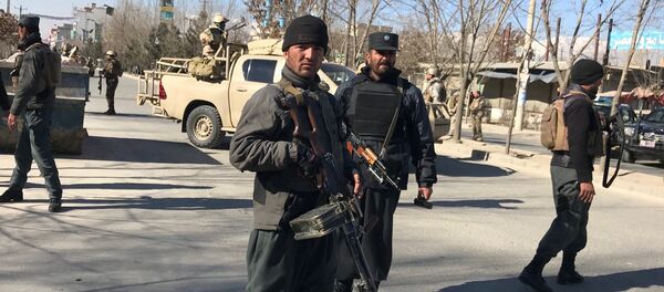Afghan policemen stand guard at the site of a blast in Kabul, Afghanistan December 28, 2017 - Sputnik International