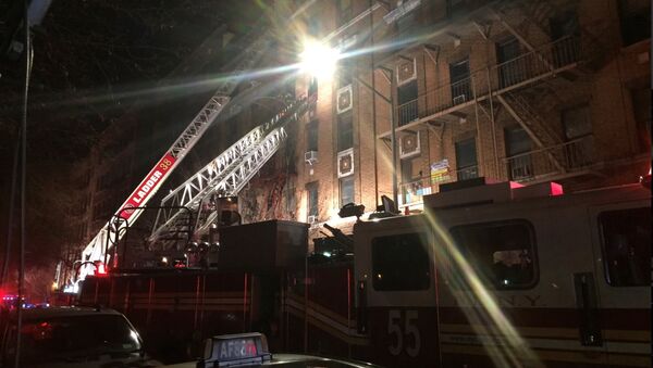 New York Fire Department ladder trucks deploy at a building fire in the Bronx borough of New York City - Sputnik International