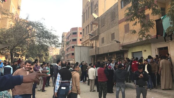 People are seen outside the Mar Mina Church after a blast, in Helwan district on the outskirts of Cairo, Egypt after a blast December 29, 2017 - Sputnik International