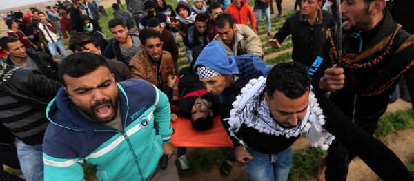 A wounded Palestinian demonstrator is evacuated during clashes with Israeli troops at a protest against U.S. President Donald Trump's decision to recognize Jerusalem as the capital of Israel, near the border with Israel in the southern Gaza Strip December 29, 2017 A wounded Palestinian demonstrator is evacuated during clashes with Israeli troops at a protest against U.S. President Donald Trump's decision to recognize Jerusalem as the capital of Israel, near the border with Israel in the southern Gaza Strip December 29, 2017 - Sputnik International