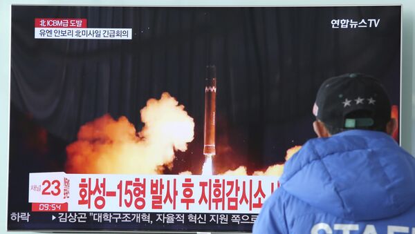 A man watches a TV screen showing what the North Korean government calls the Hwasong-15 intercontinental ballistic missile, at the Seoul Railway Station in Seoul, South Korea, Thursday, Nov. 30, 2017 - Sputnik International