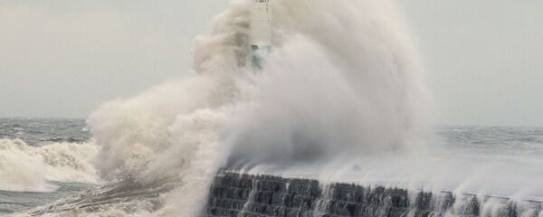 Waves crash over the stone jetty wall in Aberystwyth in west Wales as Storm Eleanor lashed Britain with violent storm-force winds of up to 100mph, leaving thousands of homes without power and hitting transport links Wednesday Jan. 3, 2018 - Sputnik International