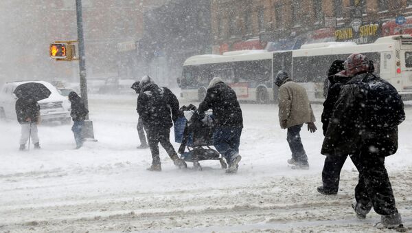 People struggle against wind and snow as they cross 125th street in upper Manhattan during a snowstorm in New York City, New York, U.S., January 4, 2018 - Sputnik International