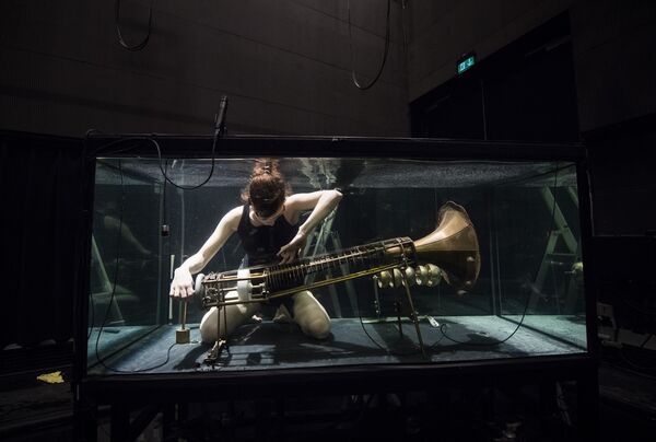 A member of the Between Music band, performs with a custom-made instrument in a glass water tank during a rehearsal ahead of the AquaSonic underwater concert on April 19, 2017 in Aarhus, Denmark - Sputnik International