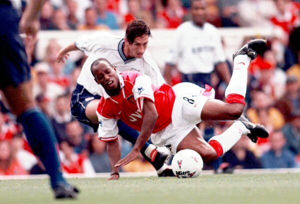 Arsenal's Ian Wright (8) is fouled by Justin Edinburgh of Tottenham Hotspur, during their FA Premier League match at Highbury, London Saturday Aug. 30, 1997 Arsenal's Ian Wright (8) is fouled by Justin Edinburgh of Tottenham Hotspur, during their FA Premier League match at Highbury, London Saturday Aug. 30, 1997 - Sputnik International