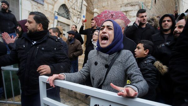 A demonstrator reacts during a protest against the visit of Greek Orthodox Patriarch of Jerusalem Theophilos III, in the West Bank city of Bethlehem January 6, 2018 - Sputnik International