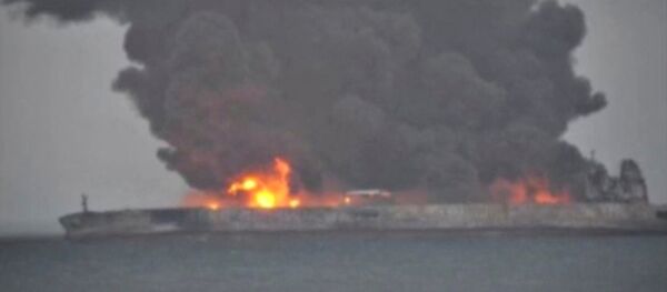 Smoke and fire is seen from Panama-registered tanker SANCHI carrying Iranian oil after it collided with a Chinese freight ship in the East China Sea, in this still image taken from a January 7, 2018 video - Sputnik International