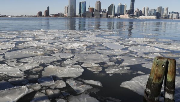 Ice floats in the Hudson River in Lower Manhattan with Jersery City, N.J., visible across the river, Sunday, Jan. 7, 2018, as bitterly cold temperatures continued through the weekend in New York - Sputnik International