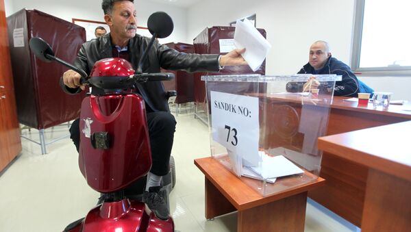 A Turkish Cypriot man casts his ballot for the parliamentary election at a polling station in the northern part of Nicosia in the self-proclaimed Turkish Republic of Northern Cyprus (TRNC), which is only recognized by Turkey, on January 7, 2018 - Sputnik International