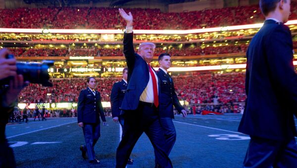 President Donald Trump walks off the field following the national anthem before the start of the NCAA National Championship game at Mercedes-Benz Stadium, Monday, Jan. 8, 2018, in Atlanta, between Alabama and Georgia. - Sputnik International