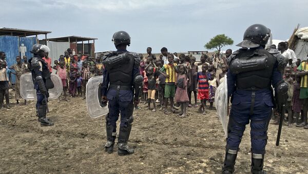 A crowd of displaced people look on as members of the U.N. multi-national police contingent provide security during a visit of UNCHR High Commissioner Filippo Grandi to South Sudan's largest camp for the internally-displaced, in Bentiu, South Sudan Sunday, June 18, 2017 - Sputnik International
