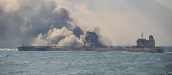 Smoke is seen from the Panama-registered Sanchi tanker carrying Iranian oil, which went ablaze after a collision with a Chinese freight ship in the East China Sea, in this January 9, 2018 handout picture released by China's Ministry of Transport January 10, 2018 - Sputnik International