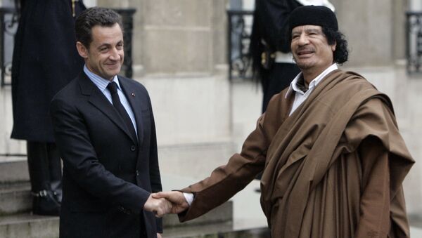 French President Nicolas Sarkozy, left, greets Libyan leader Col. Moammar Gadhafi upon his arrival at the Elysee Palace, in Paris. (File) - Sputnik International