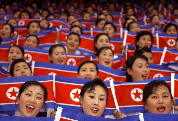 North Korean cheer team members wave their national flags during the World Students Games opening ceremony in Daegu on 21 August 2003 North Korean cheer team members wave their national flags during the World Students Games opening ceremony in Daegu on 21 August 2003 - Sputnik International
