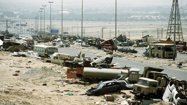 Demolished vehicles line Highway 80, also known as the Highway of Death, the route fleeing Iraqi forces took as they retreated fom Kuwait during Operation Desert Storm - Sputnik International
