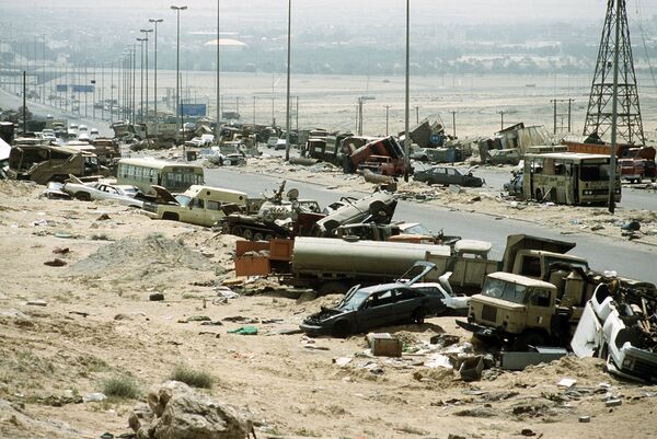 Demolished vehicles line Highway 80, also known as the Highway of Death, the route fleeing Iraqi forces took as they retreated fom Kuwait during Operation Desert Storm - Sputnik International