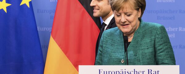 French President Emmanuel Macron, left, passes by German Chancellor Angela Merkel prior to addressing a media conference at an EU summit in Brussels on Friday, Dec. 15, 2017. French President Emmanuel Macron, left, passes by German Chancellor Angela Merkel prior to addressing a media conference at an EU summit in Brussels on Friday, Dec. 15, 2017. - Sputnik International