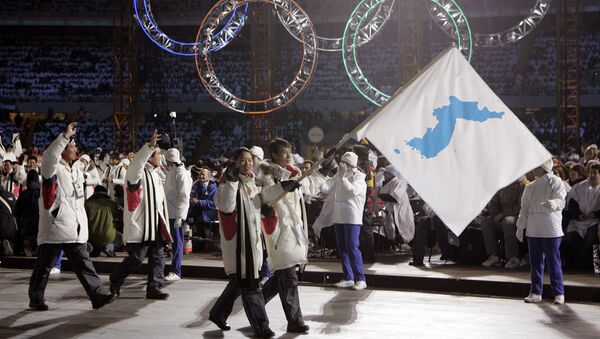In this Feb. 10, 2006, file photo, Korea flag-bearer's Bora Lee and Jong-In Lee, carrying a unification flag lead their teams into the stadium during the 2006 Winter Olympics opening ceremony in Turin, Italy - Sputnik International