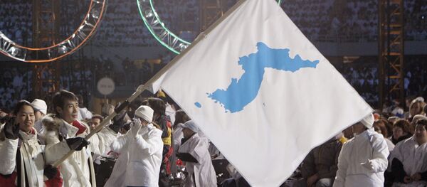 In this Feb. 10, 2006, file photo, Korea flag-bearer's Bora Lee and Jong-In Lee, carrying a unification flag lead their teams into the stadium during the 2006 Winter Olympics opening ceremony in Turin, Italy In this Feb. 10, 2006, file photo, Korea flag-bearer's Bora Lee and Jong-In Lee, carrying a unification flag lead their teams into the stadium during the 2006 Winter Olympics opening ceremony in Turin, Italy - Sputnik International