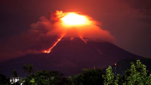 Lava cascades down the slopes of Mayon volcano as seen from Legazpi city, Albay province, around 340 kilometers (210 miles) southeast of Manila, Philippines, Monday, Jan. 15, 2018. More than 9,000 people have evacuated the area around the Philippines' most active volcano as lava flowed down its crater Monday in a gentle eruption that scientists warned could turn explosive. - Sputnik International