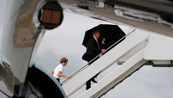 U.S. President Donald Trump and his son Barron board Air Force One as he departs West Palm Beach, Florida, U.S - Sputnik International