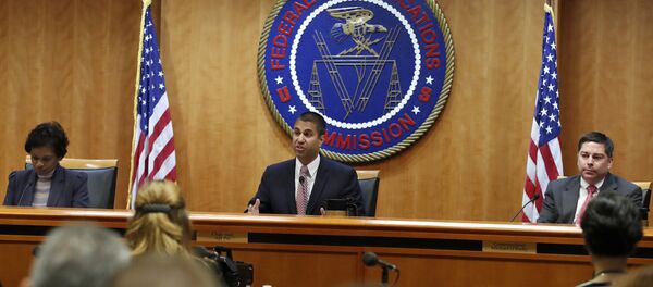 Federal Communications Commission (FCC) Chairman Ajit Pai, center, announces the vote was approved to repeal net neutrality, next to Commissioner Mignon Clyburn, left, who voted no, and Commissioner Michael O'Rielly, who voted yes, at the FCC, Thursday, Dec. 14, 2017, in Washington. (File) - Sputnik International
