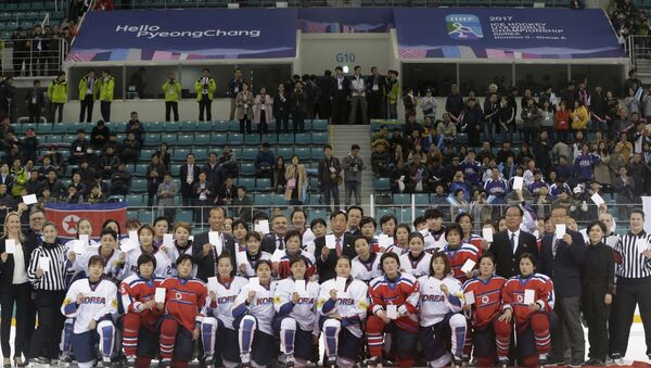 FILE - In this April 6, 2017, file photo, women's ice hockey players of South Korea, in white, and North Korea, in red, pose for a photo with International Ice Hockey Federation officials after their Ice Hockey Women's World Championship Division II Group A game in Gangneung, South Korea. North and South Korea agreed on Monday, Jan. 15, 2018, in principle to field a joint women's ice hockey team during next month's Olympics in South Korea, and relayed their position to the International Olympic Committee - Sputnik International